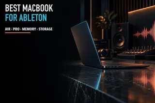 Dark aluminum laptop in a music production studio with a coral waveform