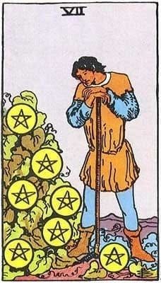 A figure hunches over a harvest tool and a shrub with 7 pentacles.