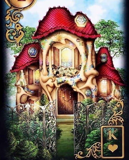 A fantastical house with a red roof and an open iron gate in front. Greenery in the front yard and above. King of Hearts symbol at lower right corner.