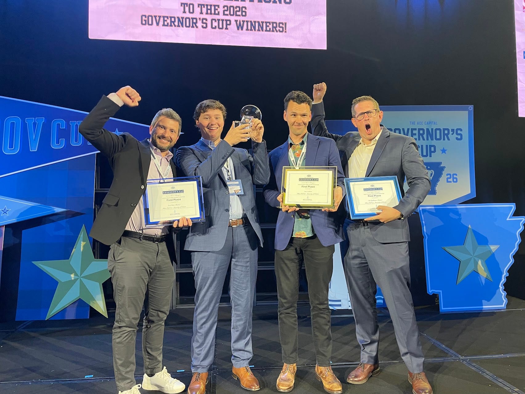 Lance Lockwood and Joey Hobbs accepting first place for Altaris MedTech at the 2026 Arkansas Governor's Cup.