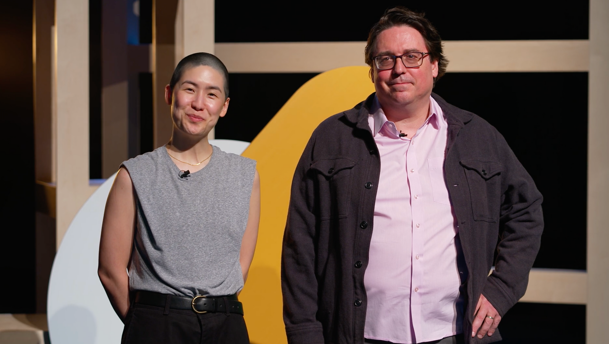 photograph of Emily and Kevin standing side-by-side on stage
