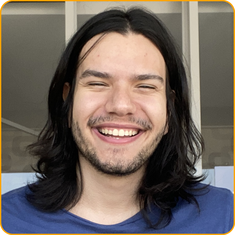 Guilherme, a student from Brazil, smiles on his patio wearing a blue t-shirt.
