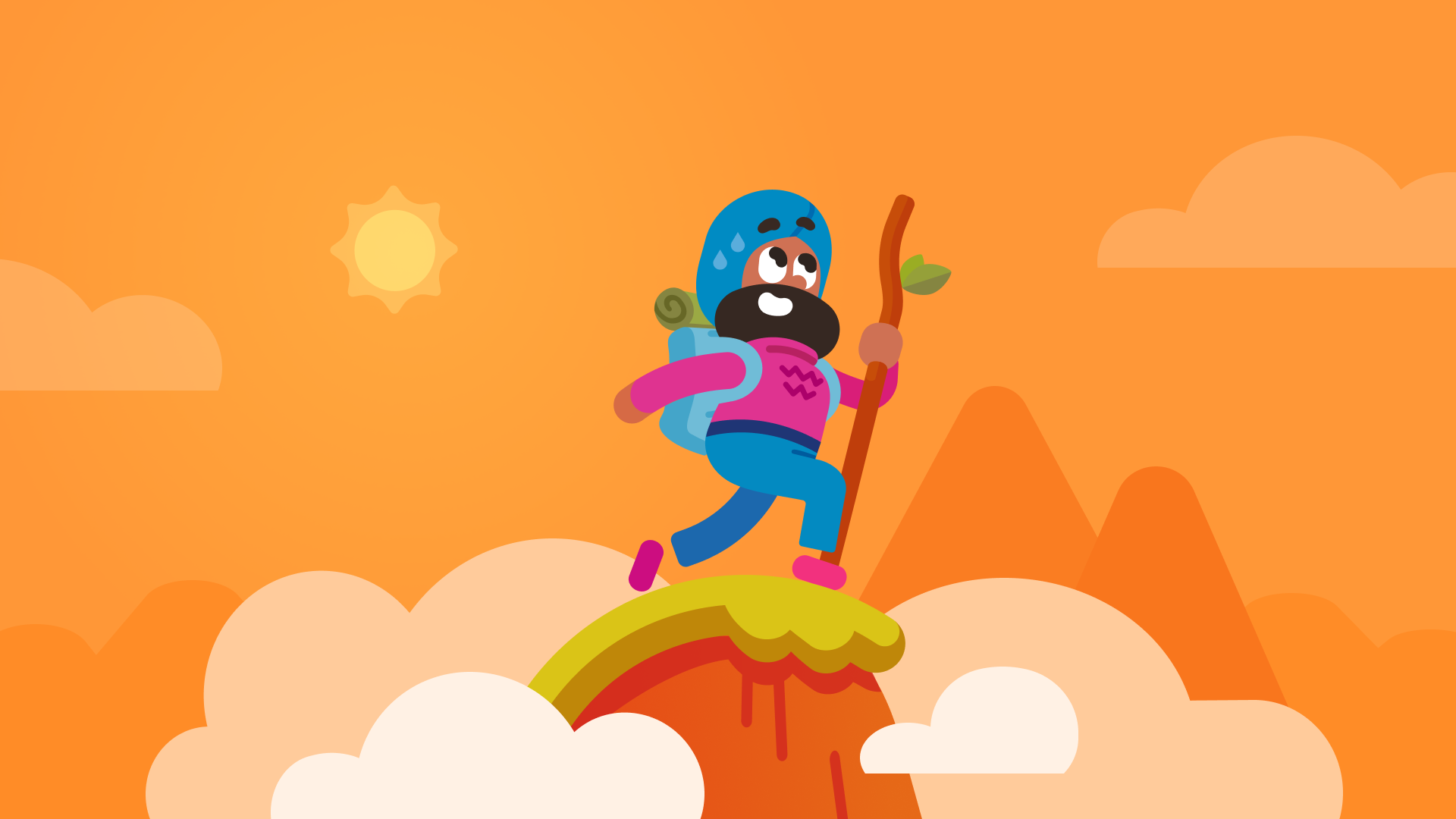 Vikram hiking at the top of a mountain on a sunny day.