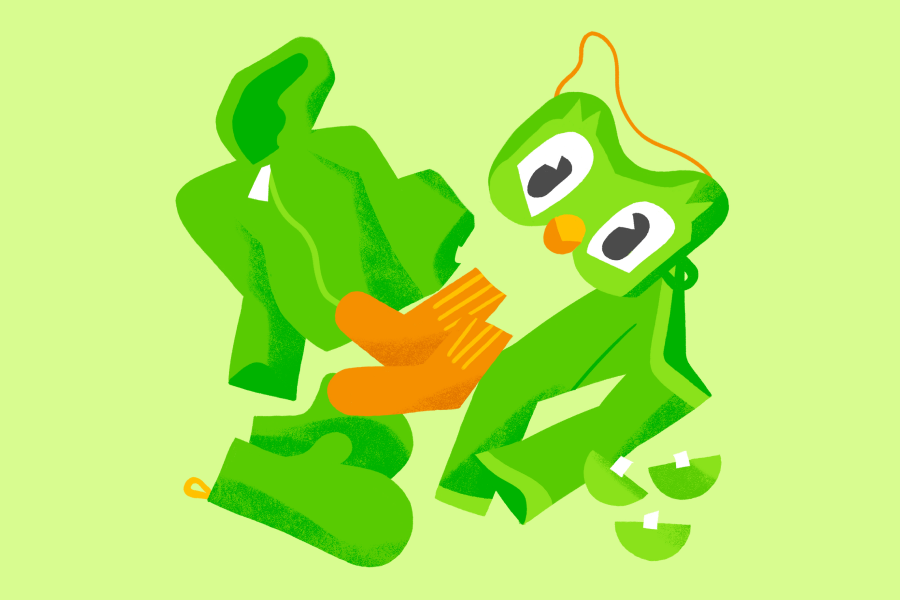 Illustration of green clothing—a hoodie, pants, and mittens—orange socks, and a Duo mask
