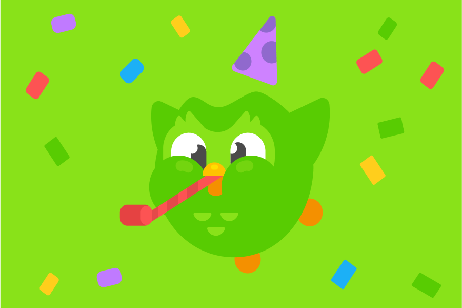 Illustration of Duo the owl wearing a party hat and blowing hard into a noisemaker with confetti falling all around him