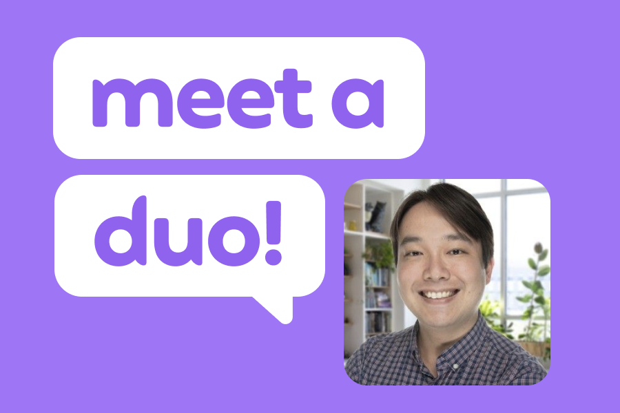 A picture of a smiling man with short hair sweeping over his forehead, next to speech bubbles with the words "Meet a Duo!"