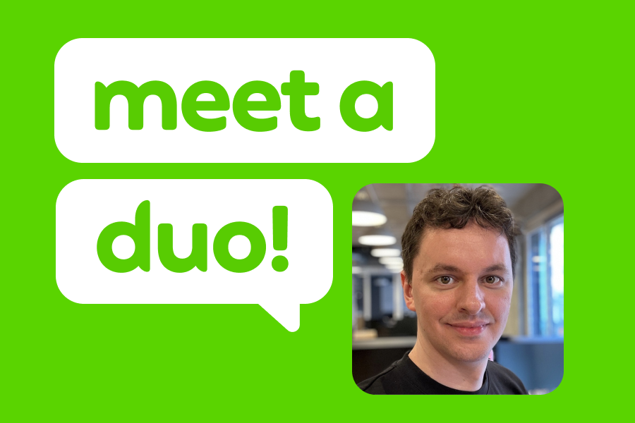 A picture of a man with short curly hair, slightly smiling, next to speech bubbles with the words "Meet a Duo!"