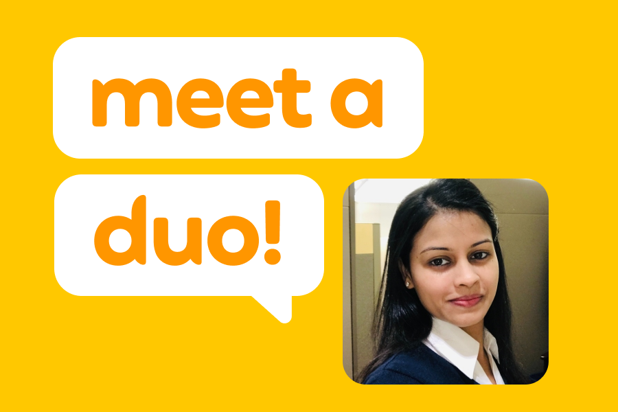 Picture of a woman in a blue sweater over a white collared shirt, next to speech bubbles that read “Meet a Duo!”