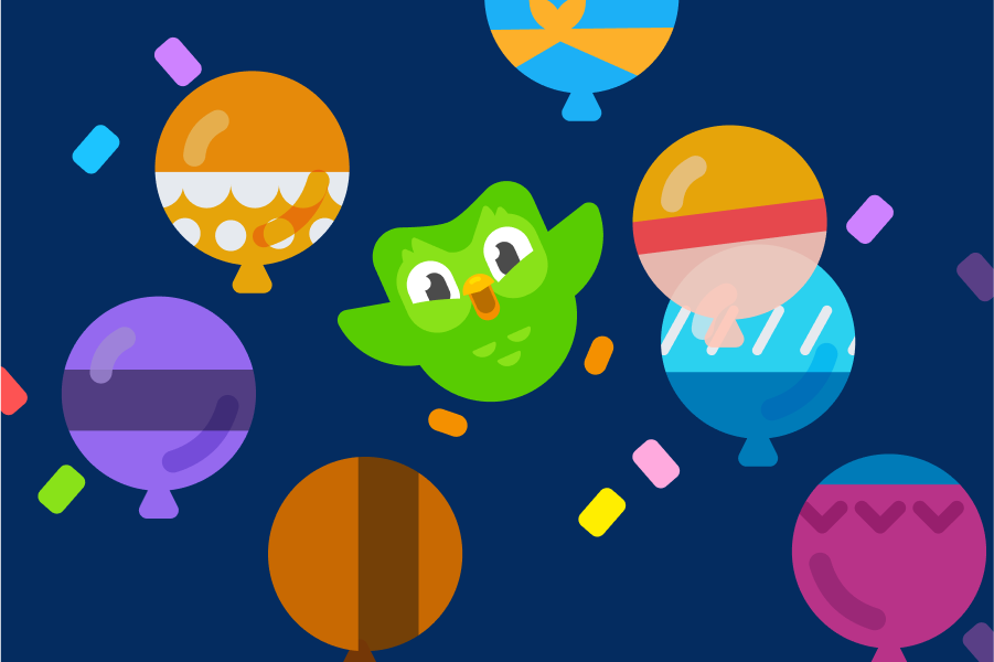 Abbildung von Duo, umgeben von Konfetti und Luftballons in verschiedenen Farben und mit verschiedenen Mustern.