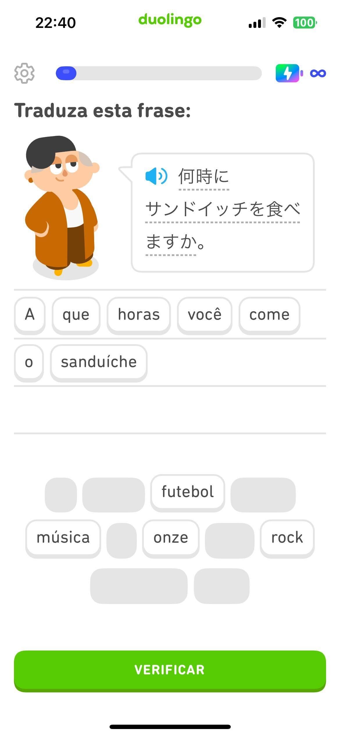 Captura de tela de um exercício com o enunciado “Traduza esta frase”. A Lin está ao lado de uma frase escrita parcialmente em kanji. A resposta é composta por blocos com palavras em português formando a frase “A que horas você come o sanduíche?”.