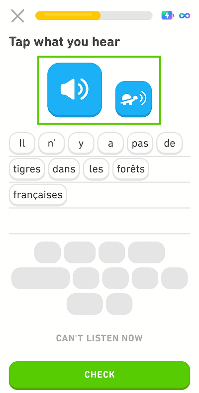 Screenshot of the app mid-lesson. The instructions given for the exercise are “Tap what you hear,” and the blank line has been filled in with words from the word bank. There is a blue button with a speaker icon and a smaller blue button with an image of a turtle. Both are highlighted in green.