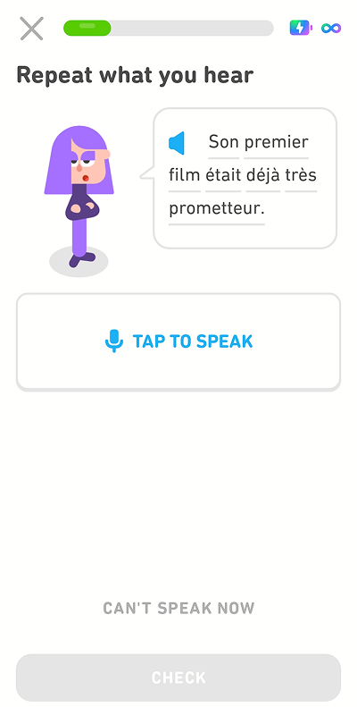 Screenshot of the app mid-lesson. The instructions given for the exercise are “Repeat what you hear,” and instead of an empty speech bubble, the speech bubble has a sentence in French. There is a button below the speech bubble with a microphone icon that says “Tap to speak.”