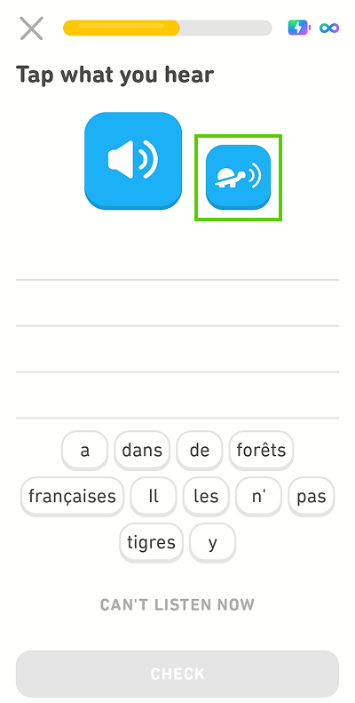 Screenshot of the app mid-lesson. The instructions given for the exercise are “Tap what you hear,” with a blank space and a word bank of French words beneath. There is a blue button with a speaker icon and a smaller blue button with an image of a turtle. The turtle button is highlighted in green.