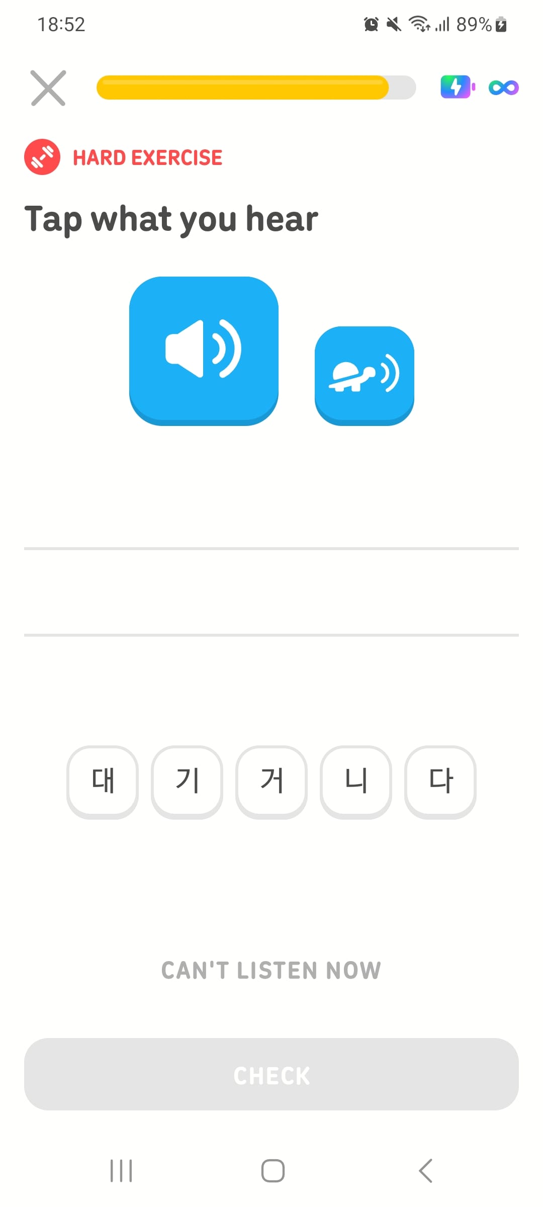 Screenshot of a Duolingo lesson with the instructions “Tap what you hear.” A blue speaker button and a blue turtle button are at the top of the screen, and various tiles with different Korean characters are presented as choices.