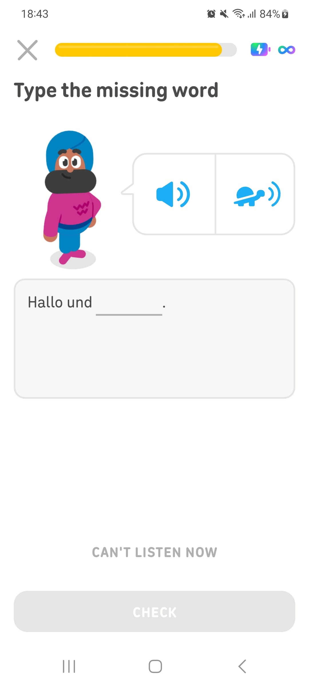 Screenshot of a Duolingo lesson with the instructions “Type the missing word.” Duolingo character Vikram is shown with a speaker icon and a turtle icon next to him, representing the options to listen to the phrase at normal speed or more slowly. Beneath him is a German sentence with one word missing.