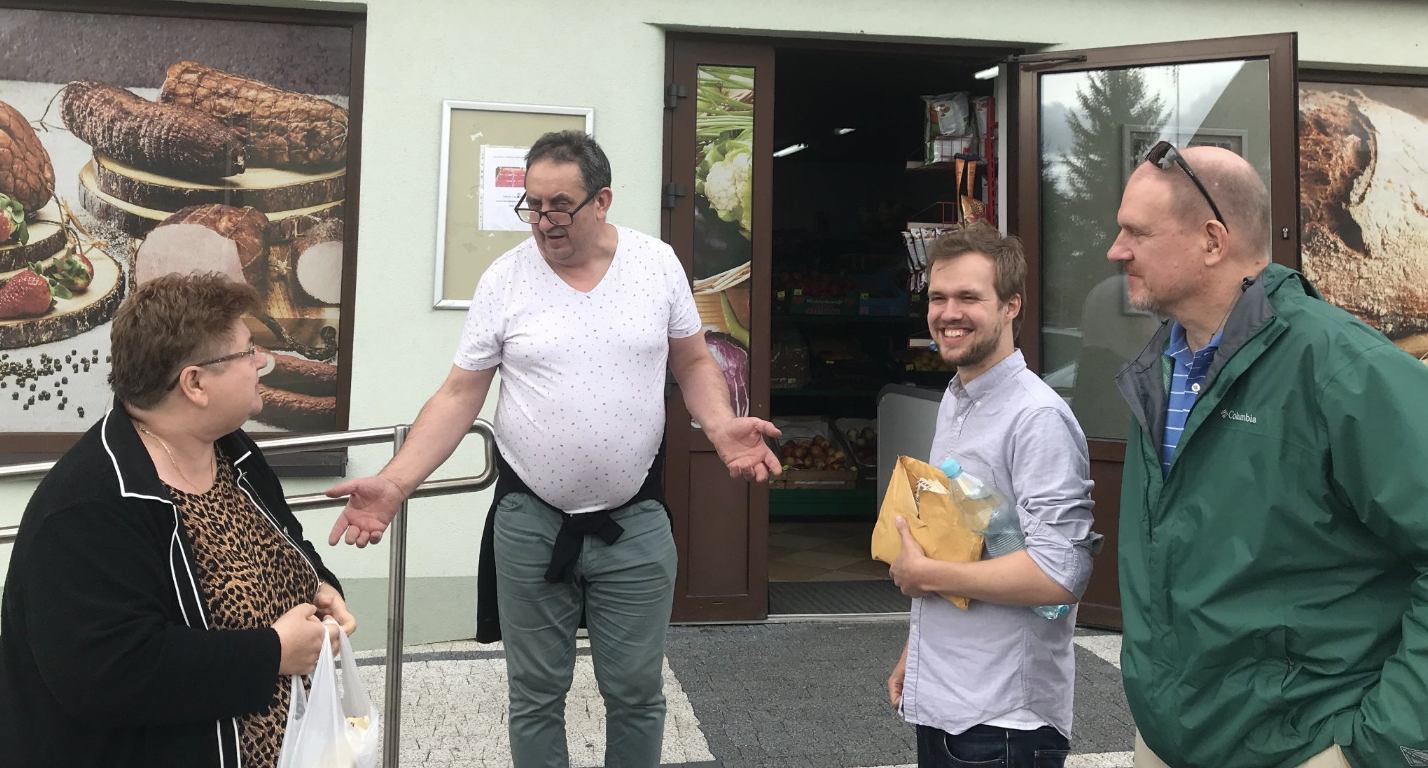 My Aunt Halina, the shopkeeper Bogdan, me holding my family’s letters, and my father standing in front of Bogdan’s store, discussing our family histories.
