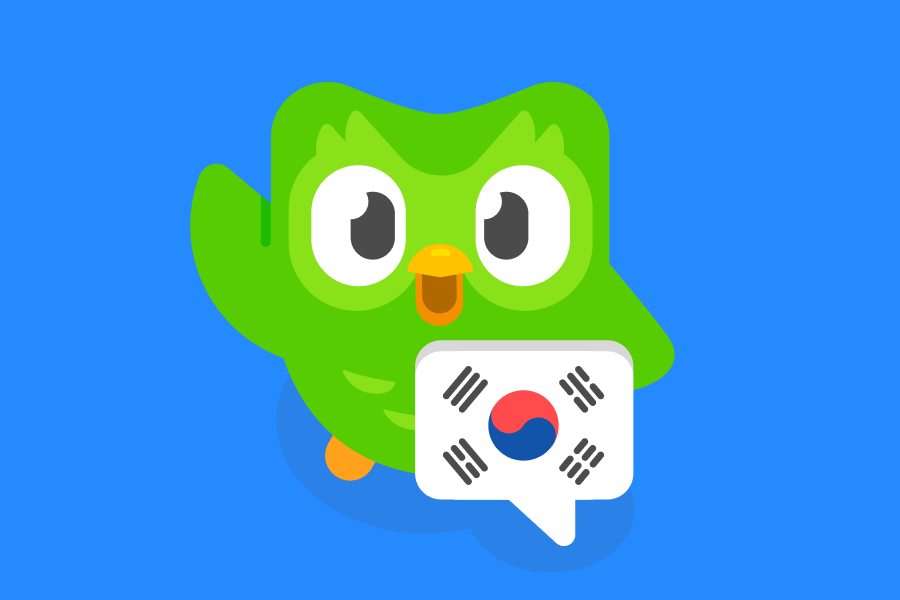 Illustration of Duo the owl standing behind a speech bubble with a Korean flag in it and waving to the viewer.