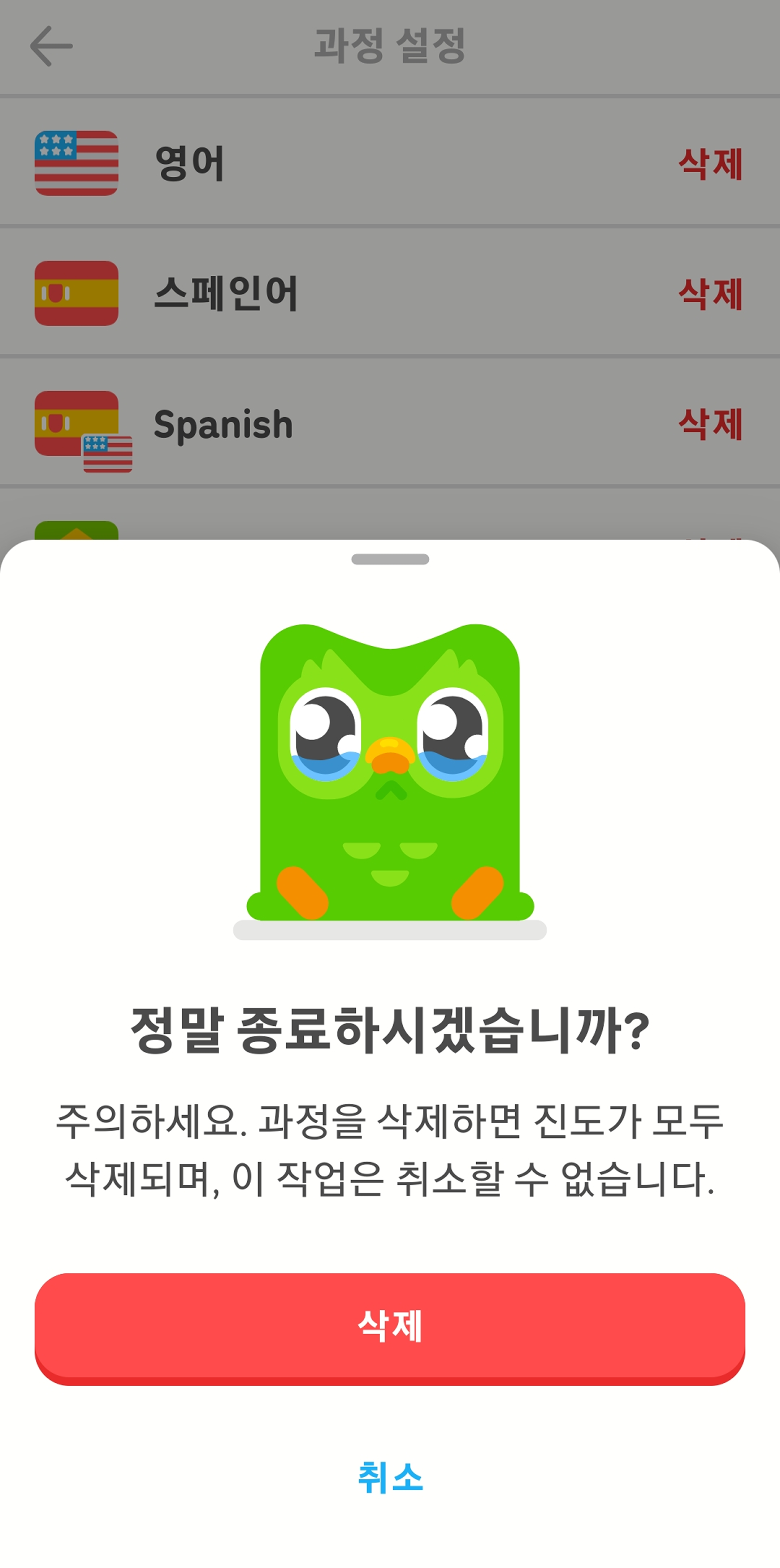 듀오링고 앱의 “과정 설정” 메뉴를 보여주는 스크린샷. 확인을 요구하는 팝업 이미지로 눈물이 그렁그렁한 부엉이 듀오가 보인다. 그 아래 “정말 종료하시겠습니까? 주의하세요. 과정을 삭제하면 진도가 모두 삭제되며, 이 작업은 취소할 수 없습니다”라고 쓰여 있다. 유저는 “삭제” 또는 “취소”할 수 있다.