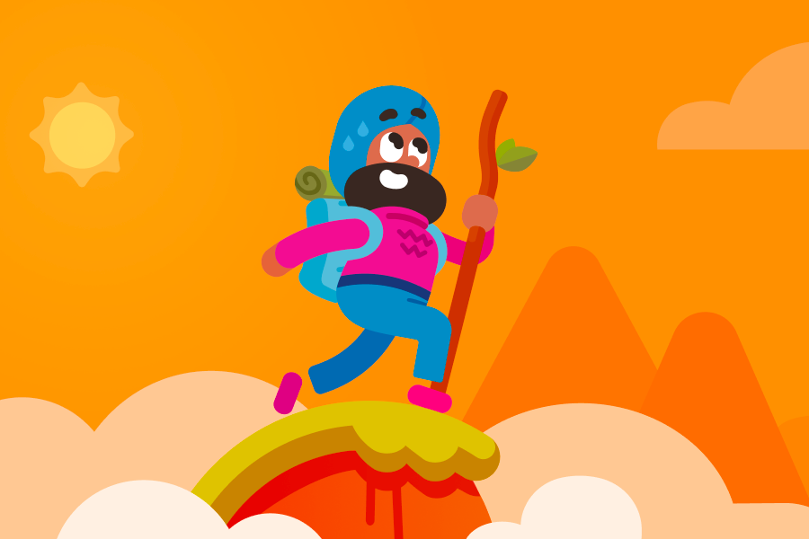 Vikram walking atop a mountain summit while wearing a backpack and holding a walking stick.