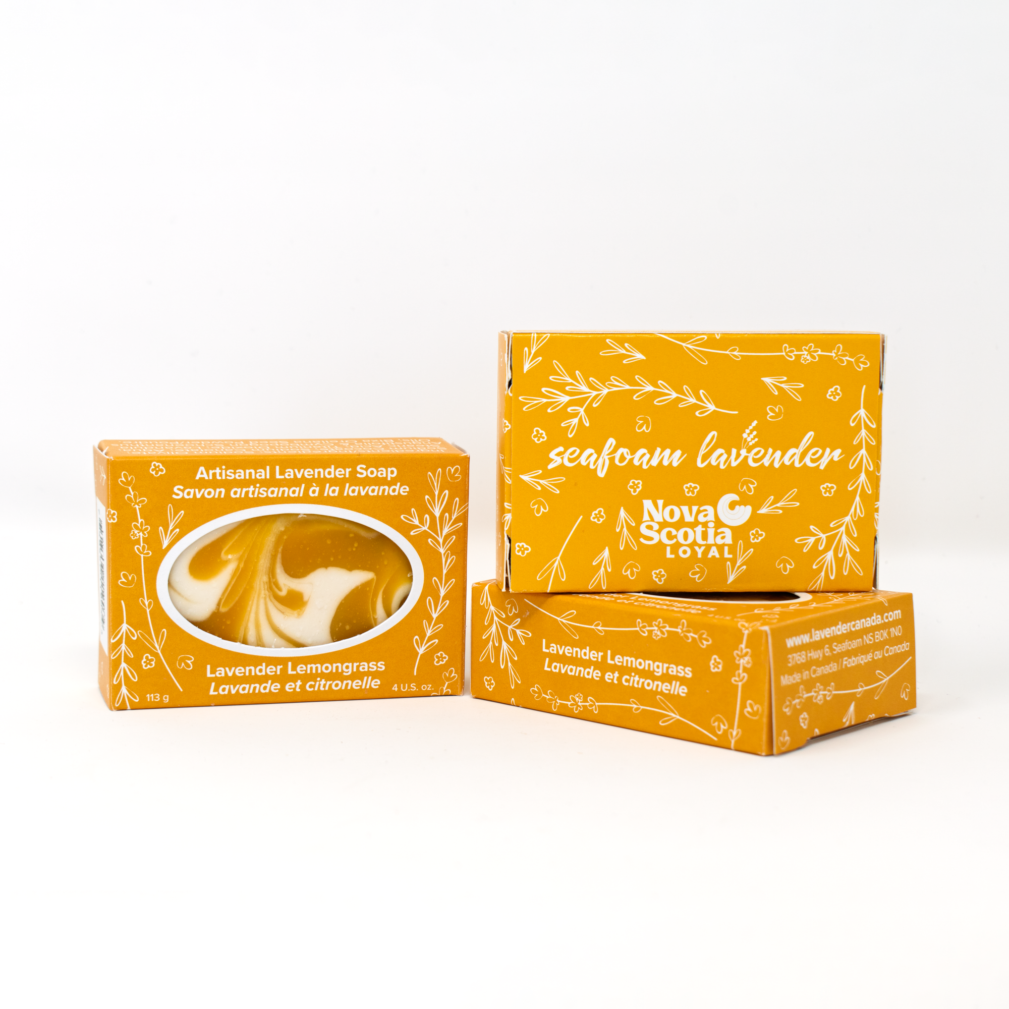 three bars of Lavender Lemongrass soap in yellow boxes decorated with white botanical motifs in a whimsical, illustrative style