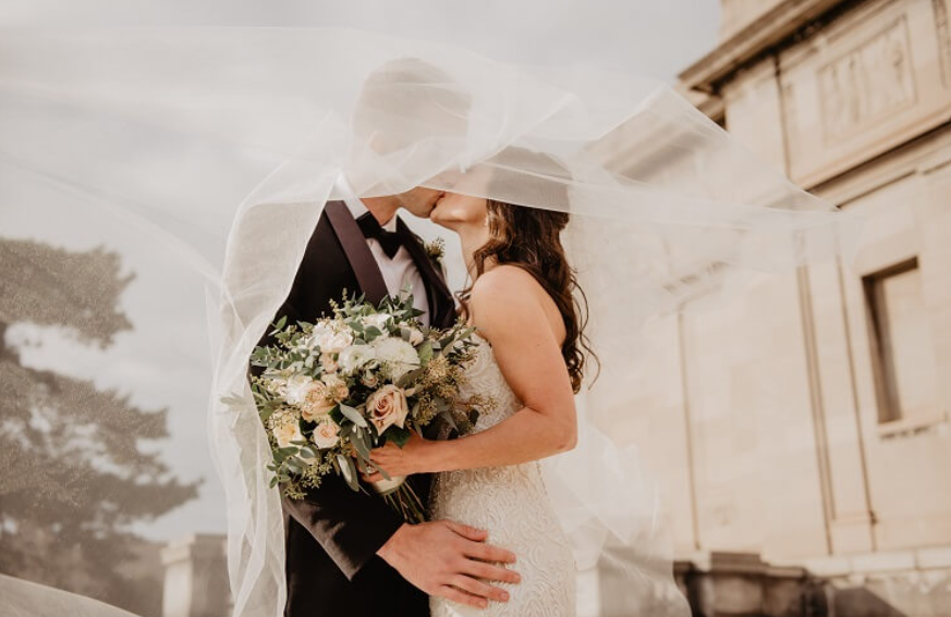 A married man and woman kissing