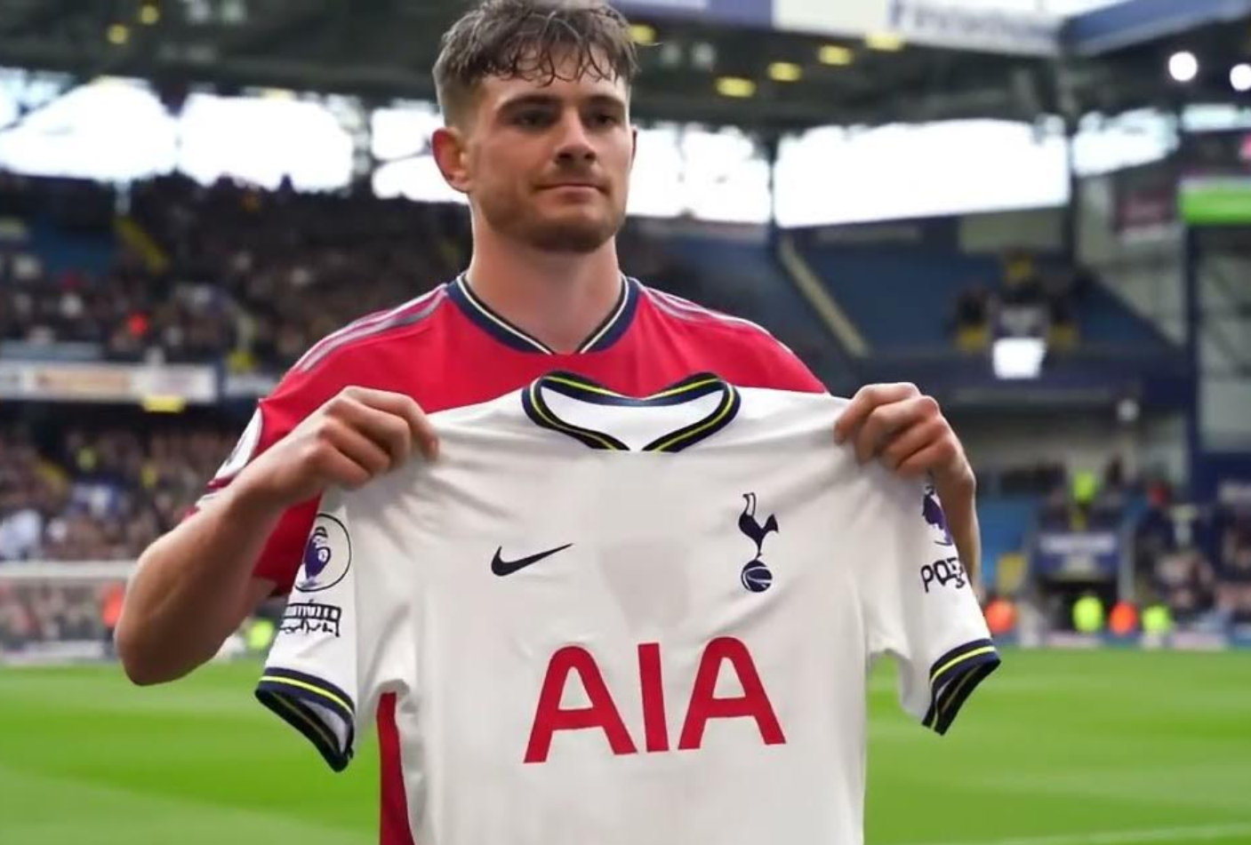 An athlete is holding a jersey