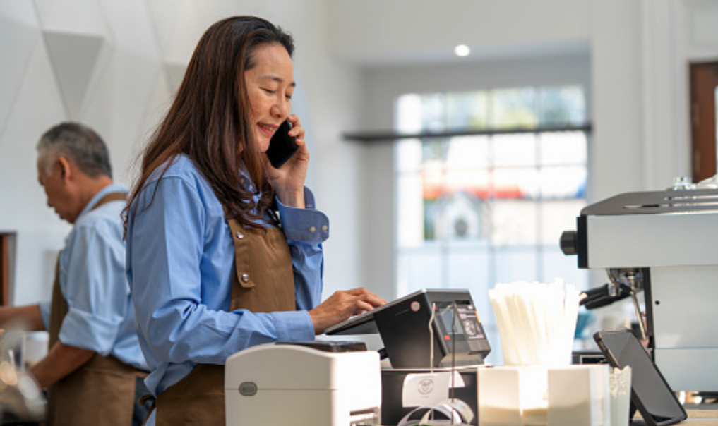 Woman at a retail store working.