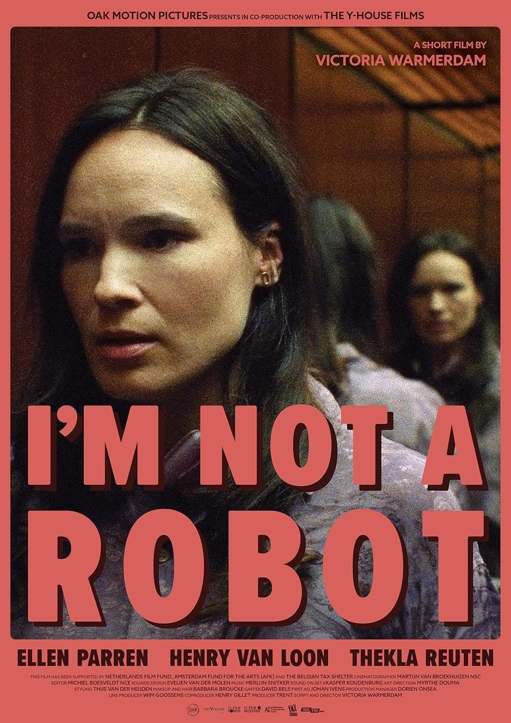 A woman stares at her own reflection, which is reflected in another mirror behind her. The soft red "I'm Not A Robot" text appears above her. Movie poster.
