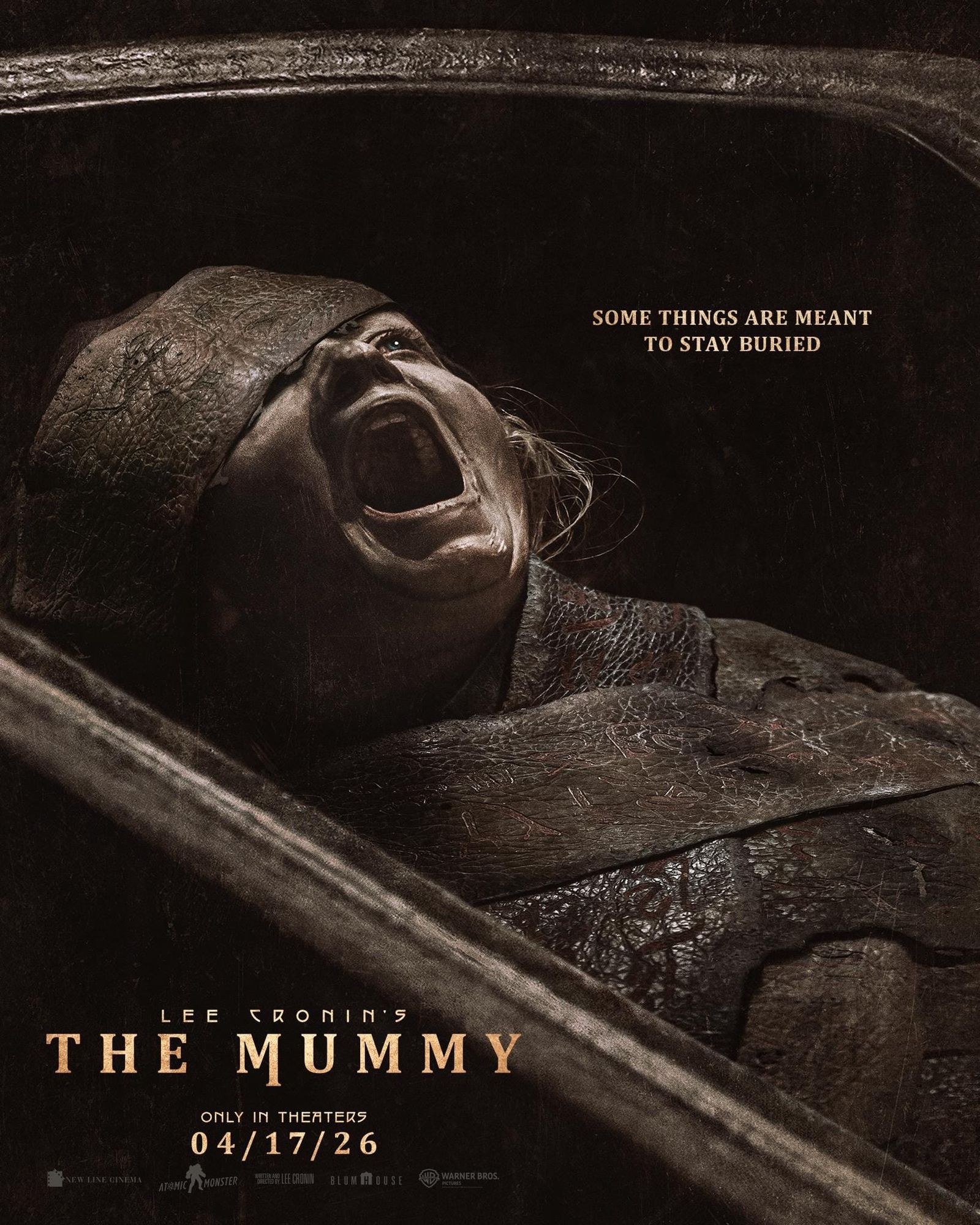 Lee Cronin's The Mummy poster. Katie shown screaming in the sarcophagus with the tagline "Some things are meant to stay buried" printed above her.