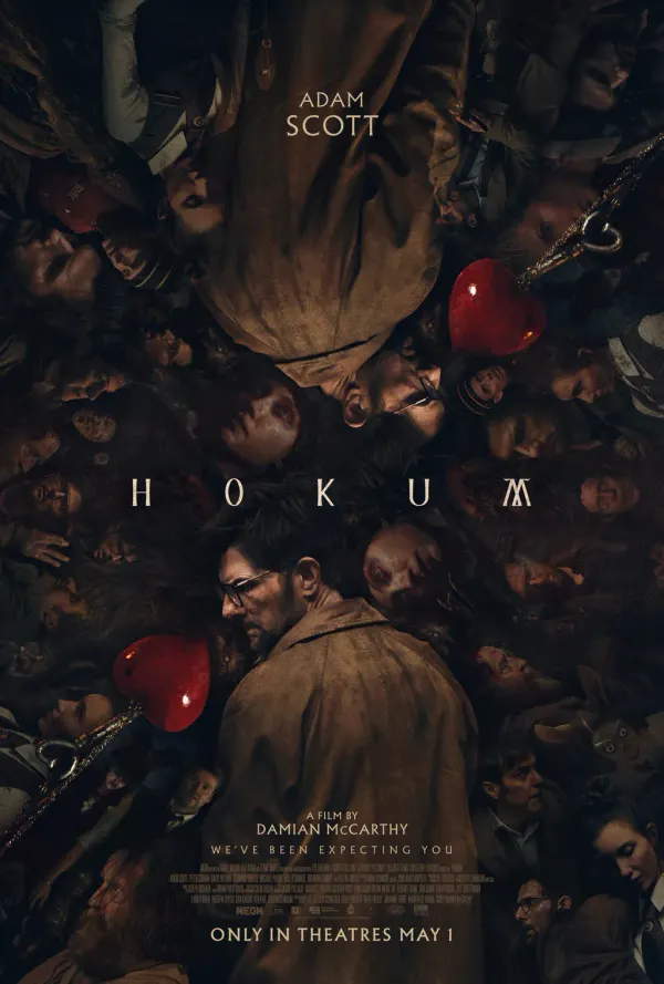 Hokum poster, featuring Ohm reflected vertically surrounded by the ensemble of characters in the film, two heart pendants and the text "HOKUM A film by Damian Mc Carthy We've Been Expecting Y