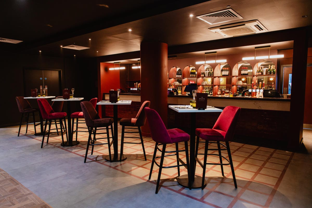 The Seven premium dining room at Utilita Arena Sheffield, showing the bar and set dining tables.