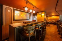 Interior of The Headliner Lounge at Motorpoint Arena Nottingham, with bar seating and arena-view chairs