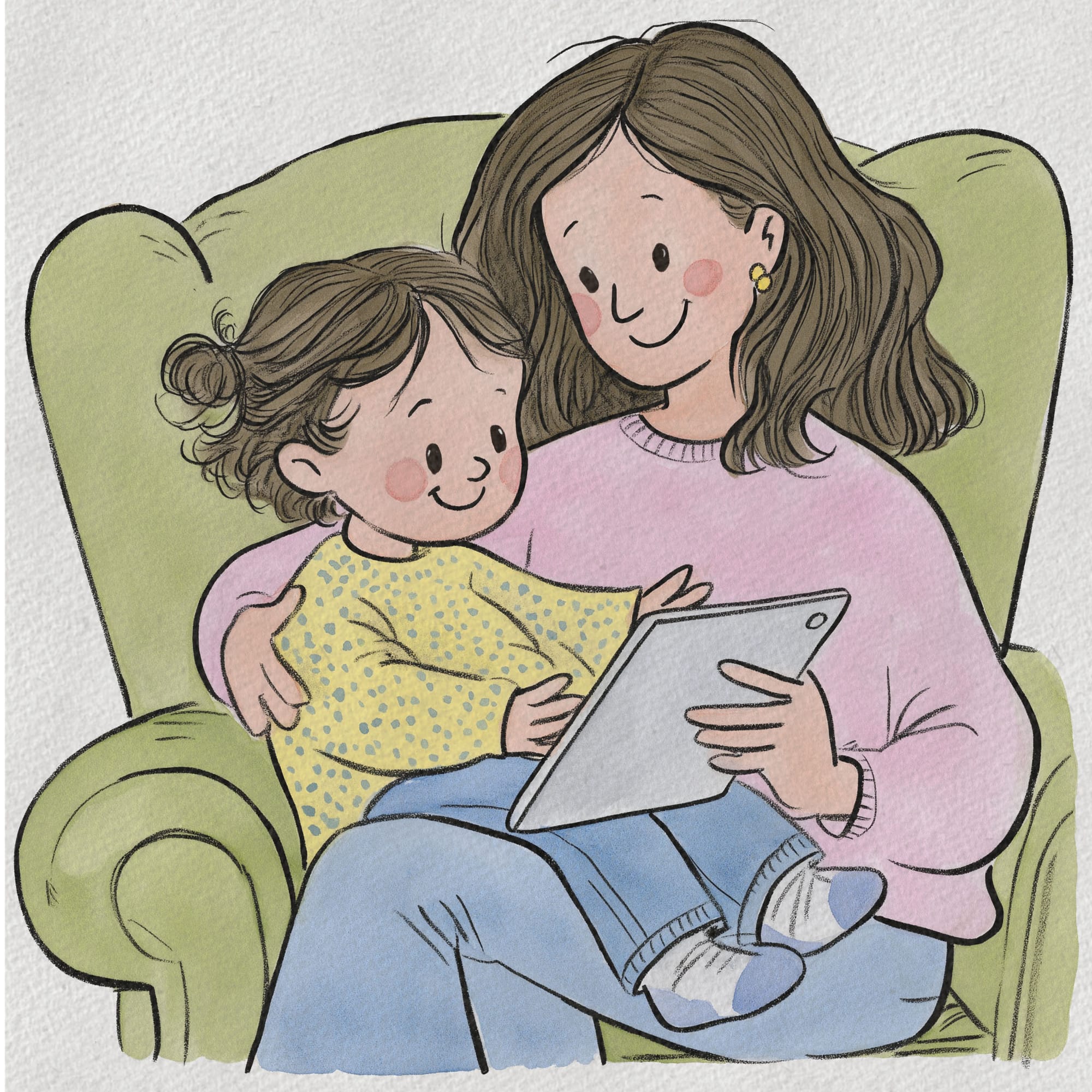 A woman in a pink jumper holds a tablet while the child on her lap looks up at her mid-story, both settled into a green armchair.