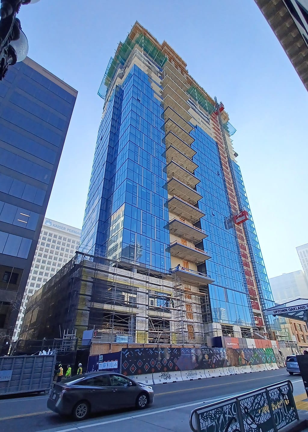 A tall apartment under construction in Oakland https://commons.wikimedia.org/wiki/File:Building_under_construction_on_Broadway.jpg