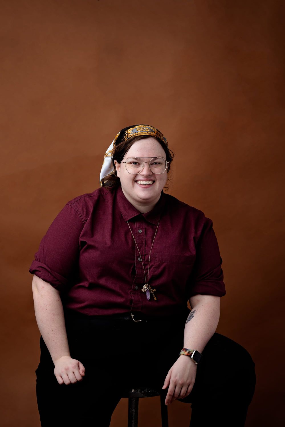 A seated portrait of the author, Kat Grant
