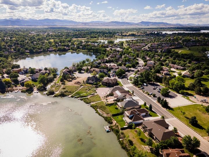 An aerial view of a northern Colorado Front Range residential neighborhood beside a lake.