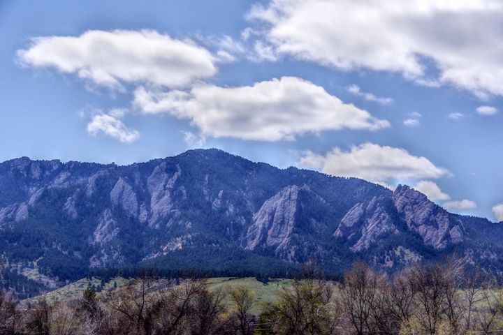 The Front Range foothills above Boulder County, Colorado, under a clear sky.