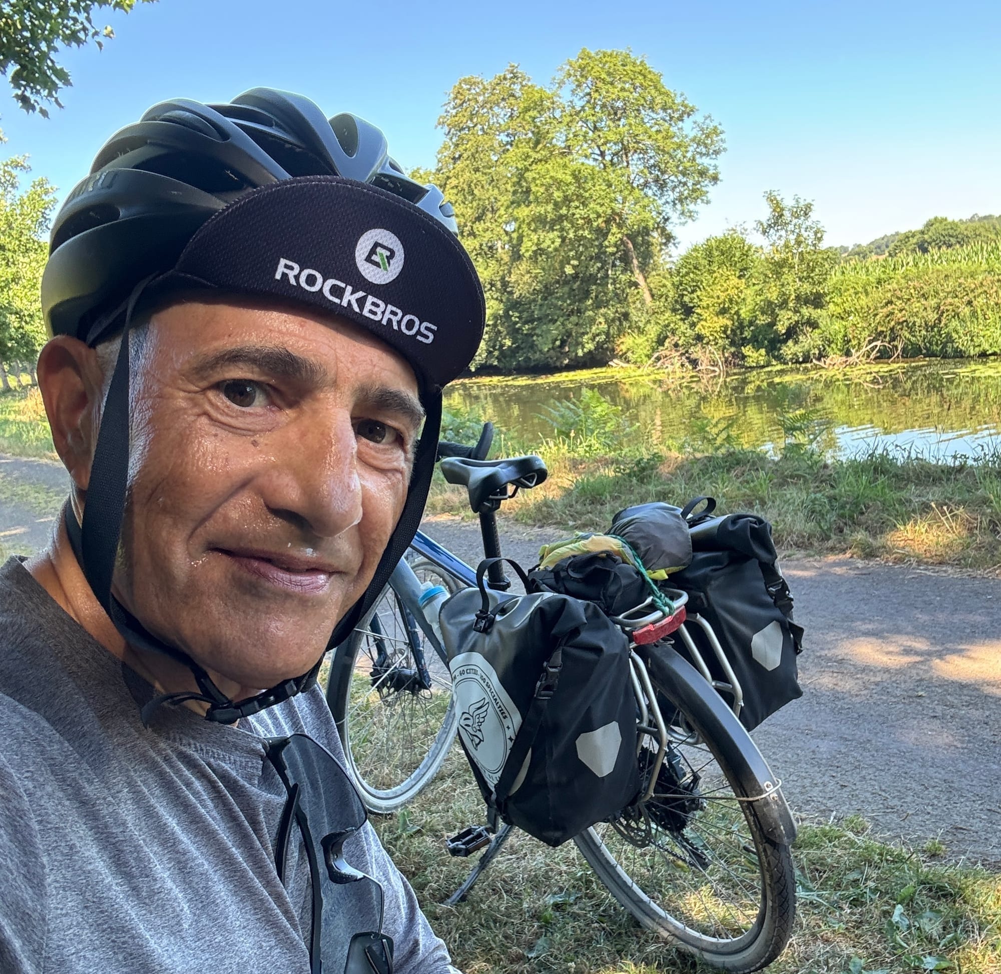 Franck beside his loaded bicycle during the 3,200 km Tour de Gaule around France.