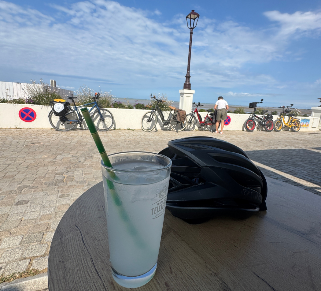 Franck’s helmet, drink and loaded bicycle during a seaside stop on the Tour de Gaule.
