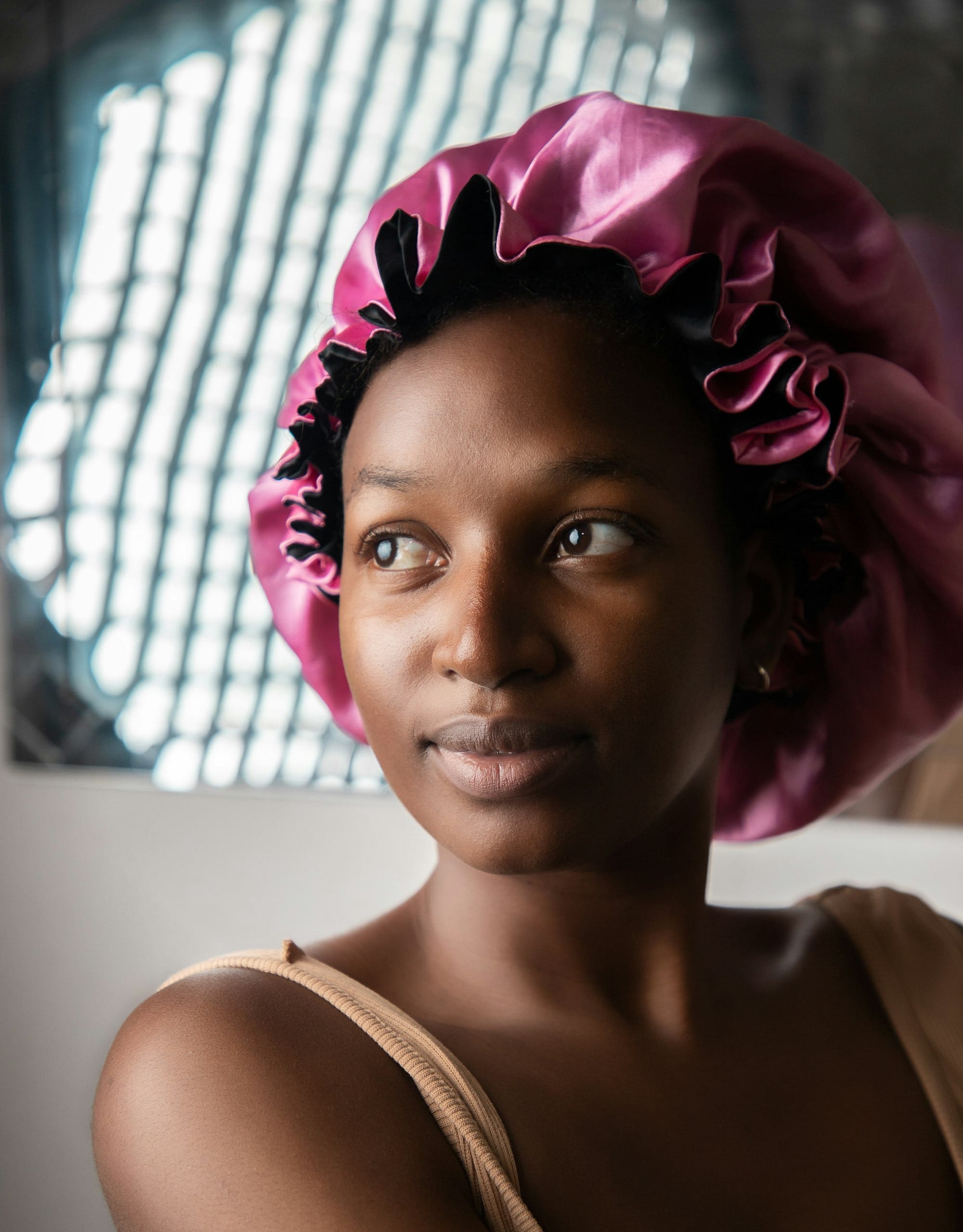 a woman with a pink hat on her head
