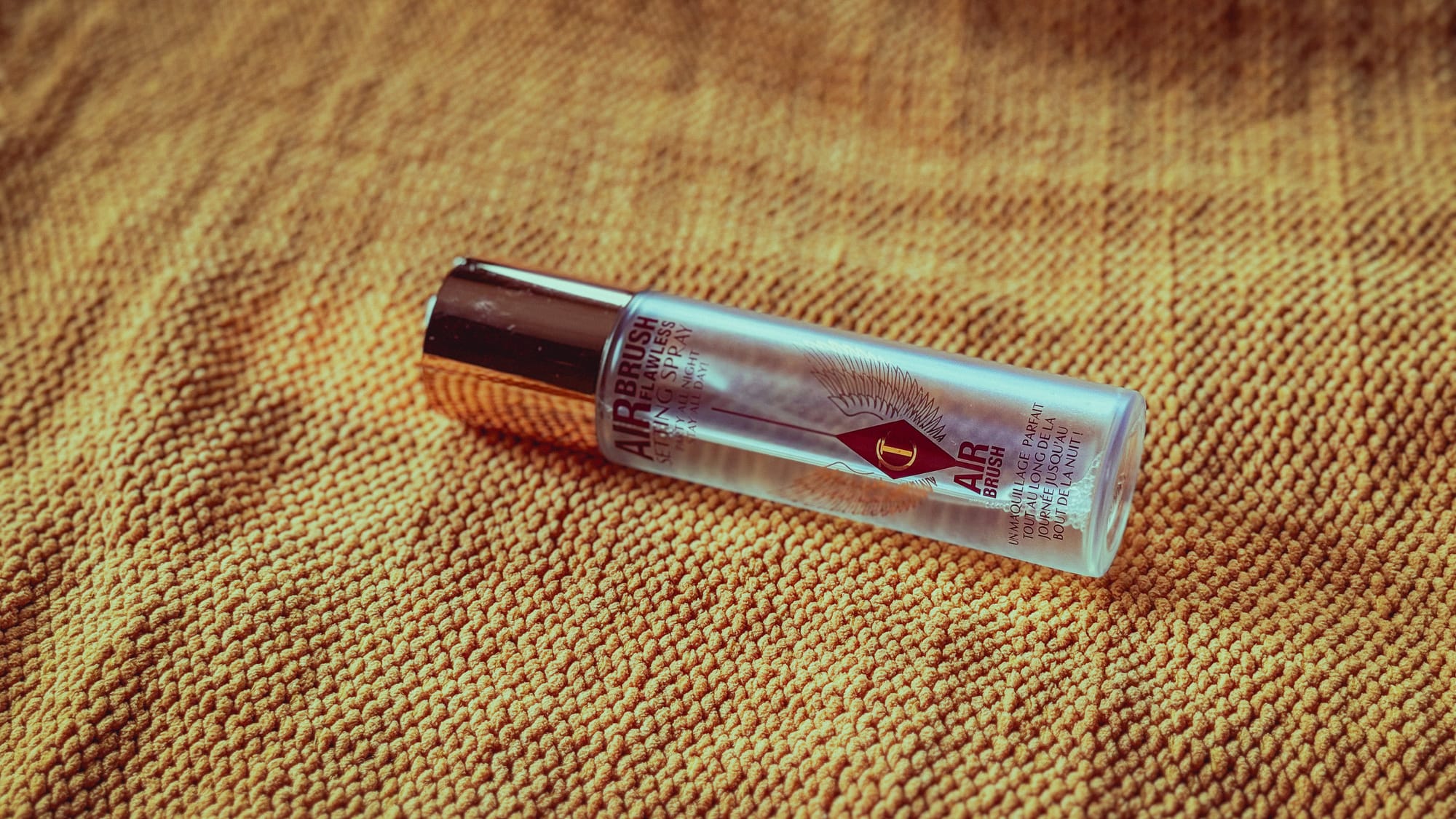 Charlotte Tilbury Airbrush Flawless Setting Spray on fabric background