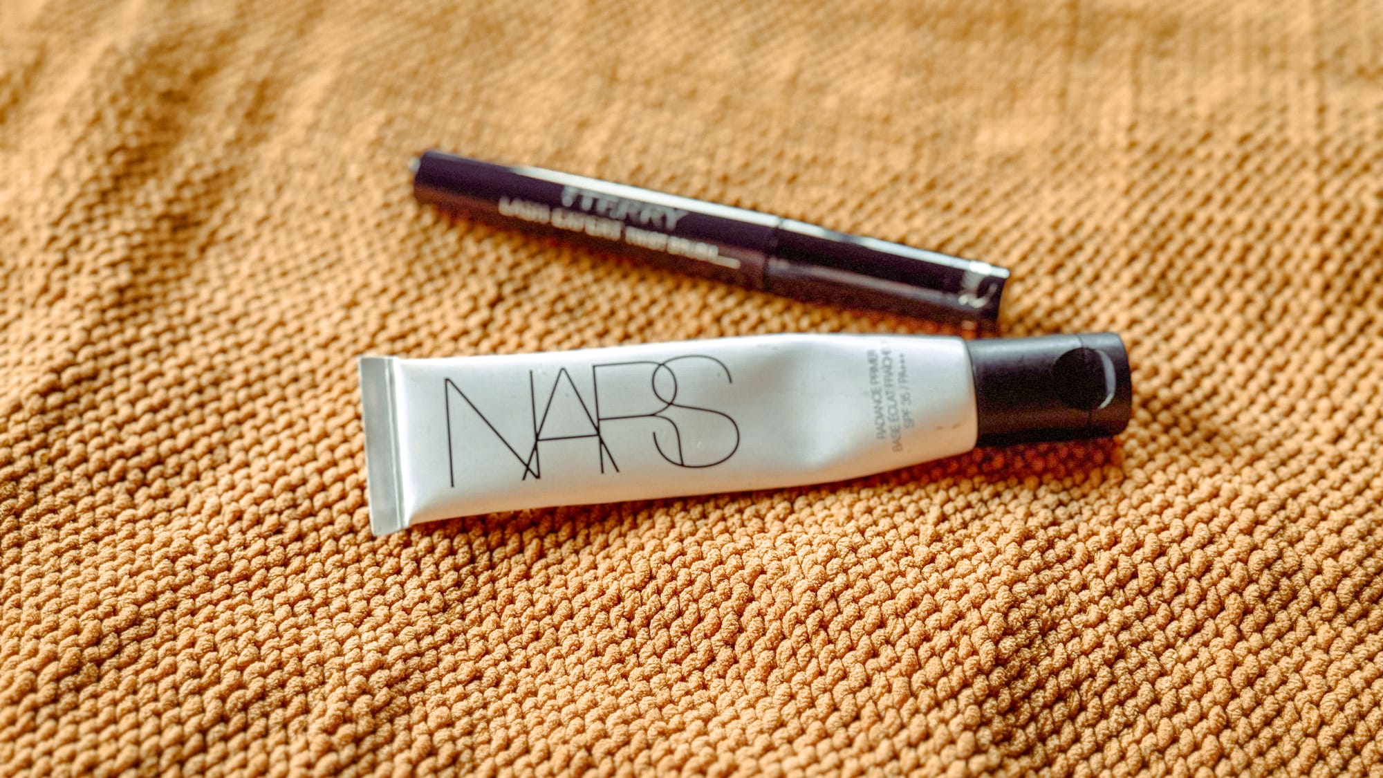 NARS Radiance Primer with SPF 35 on a textured background