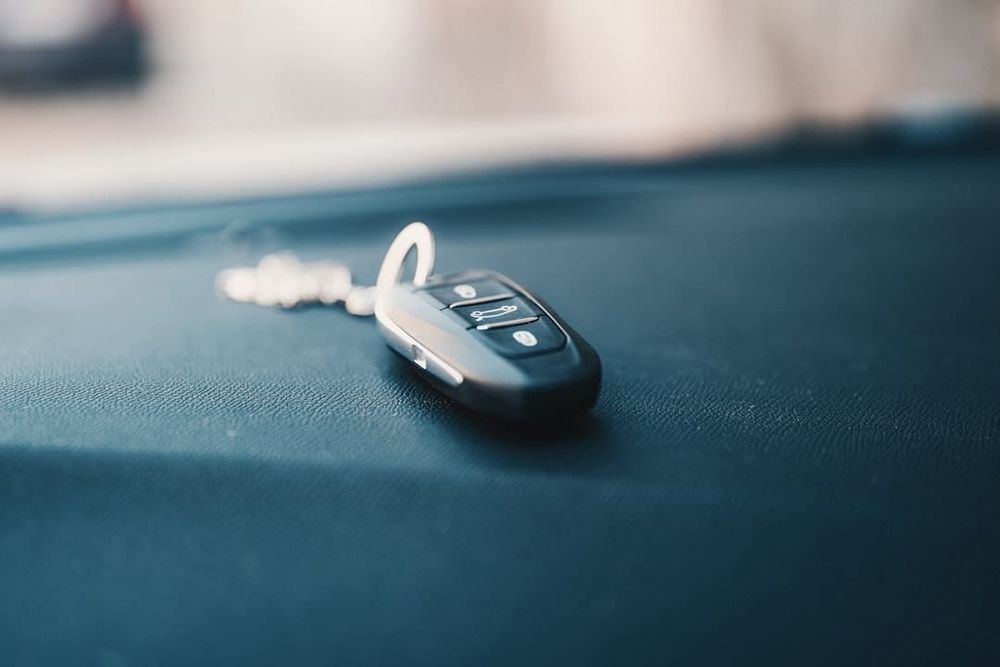 Car keys being handed over at a dealership counter