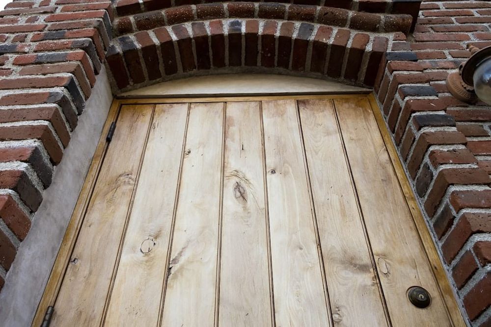 A traditional English pub exterior with wooden door and sign