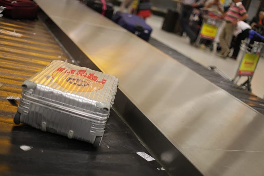 A travel suitcase and passport at an airport