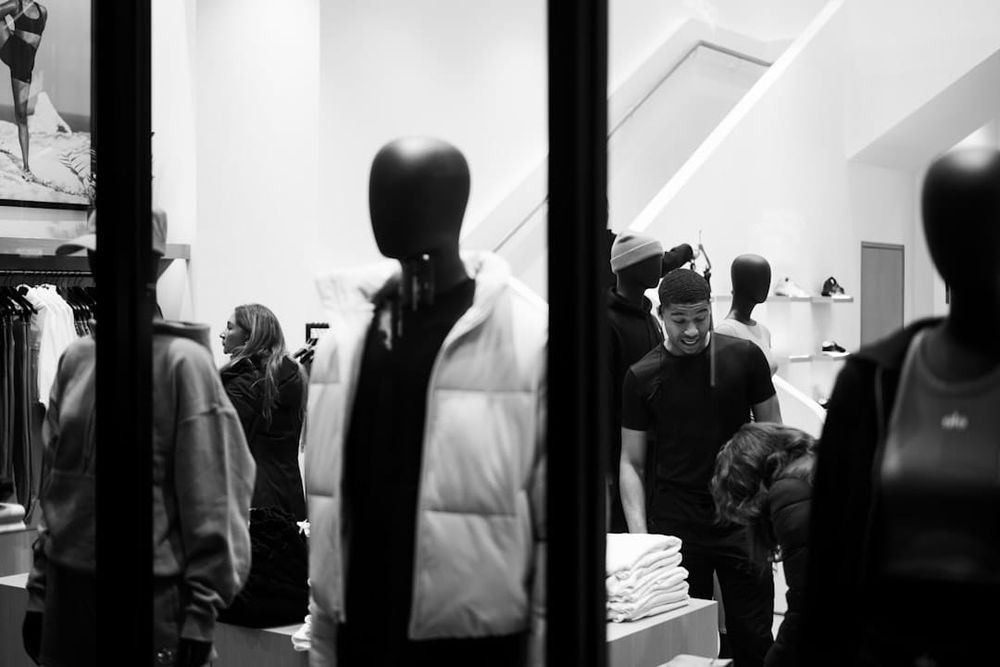 Mannequins in a clothing store window display.