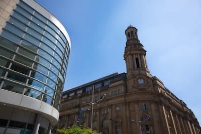 A large building with a clock tower in front of it
