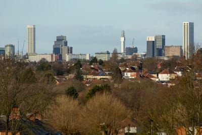 City skyline with modern buildings and residential homes.