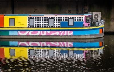 yellow blue and red boat on water