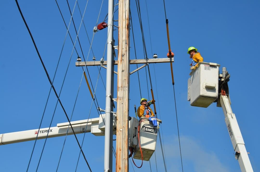 two linemen on cherry pickers